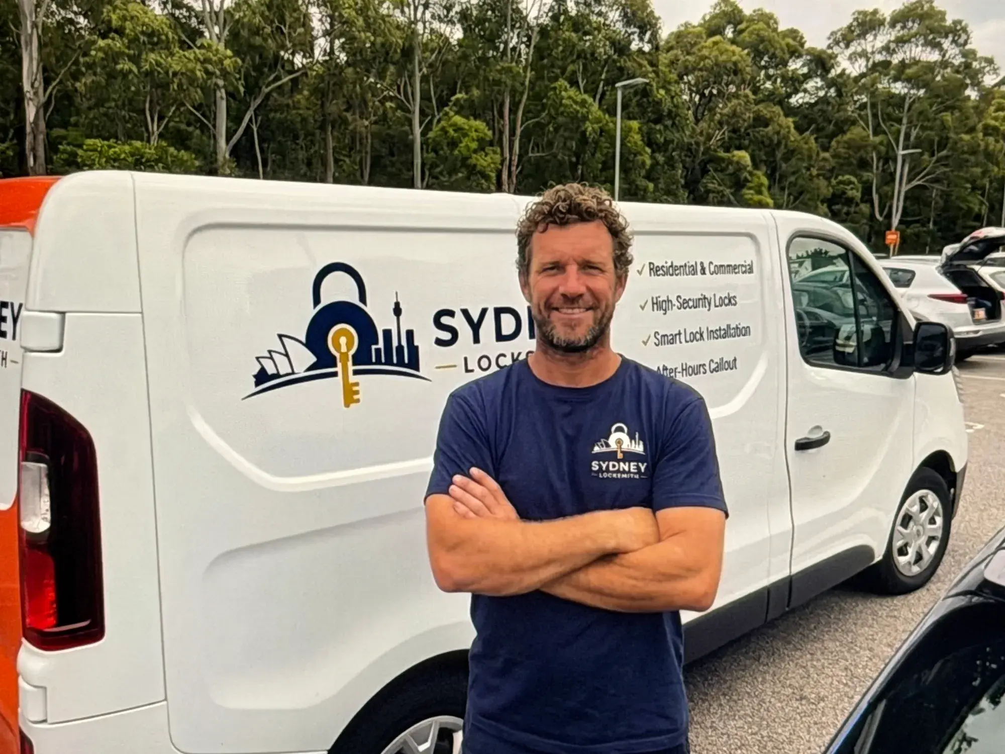 Sydney Locksmith technician in front of his marked service van